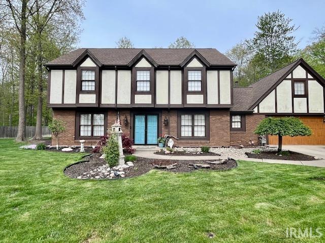 6827 Belle Plain Cv, Fort Wayne, IN 46835 - rear view of house with a yard, brick siding, fence, and stucco siding