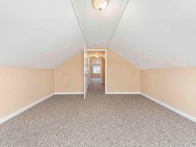 bonus room featuring baseboards, vaulted ceiling, and carpet flooring