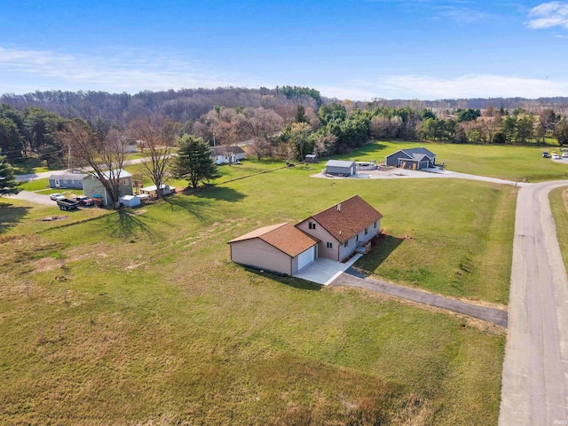 birds eye view of property featuring a wooded view