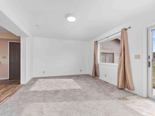 carpeted empty room with baseboards