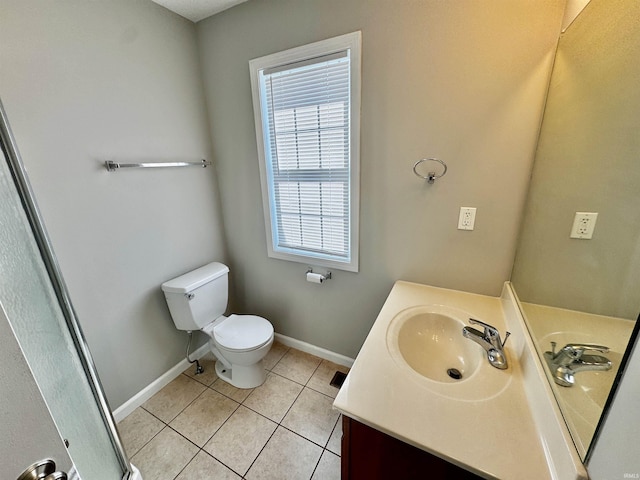 bathroom featuring baseboards, tile patterned flooring, vanity, and toilet