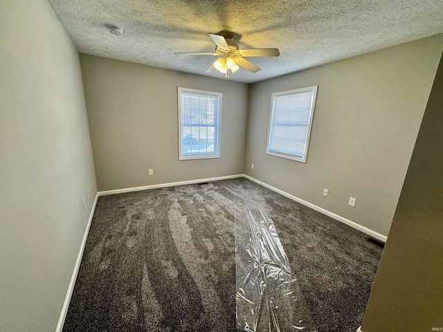 spare room with a textured ceiling, baseboards, and ceiling fan