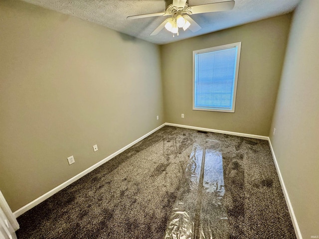 empty room featuring baseboards, carpet floors, a textured ceiling, and ceiling fan