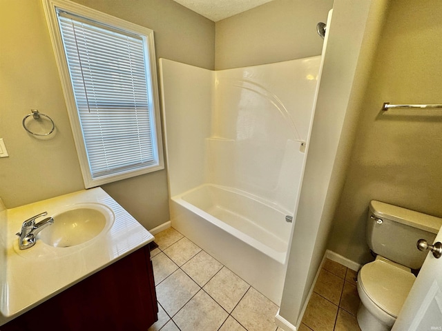 bathroom featuring toilet, tile patterned flooring, and baseboards