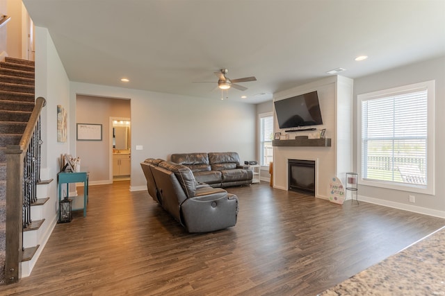 living room featuring a ceiling fan, stairs, a fireplace, dark wood-style floors, and recessed lighting