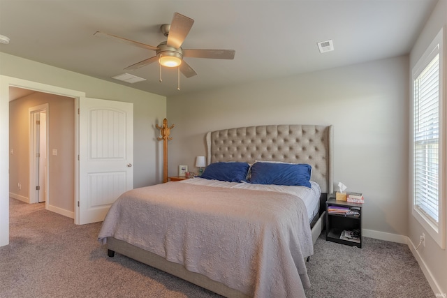 carpeted bedroom featuring visible vents, a ceiling fan, baseboards, and multiple windows
