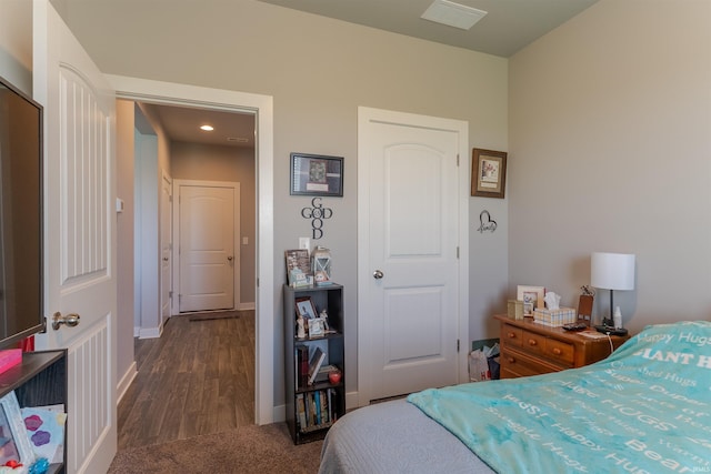 bedroom with recessed lighting, dark wood-type flooring, visible vents, and baseboards