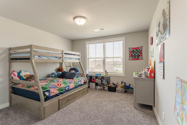 carpeted bedroom featuring baseboards and visible vents