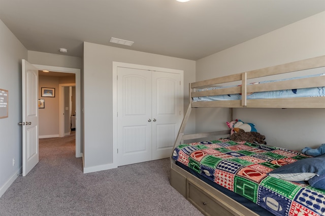 bedroom featuring carpet, a closet, baseboards, and visible vents
