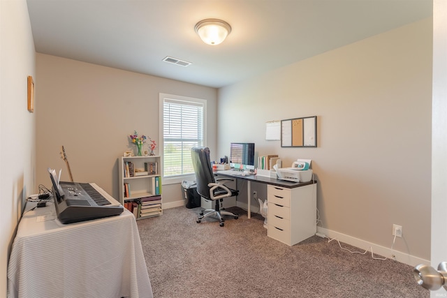 office area with carpet floors, visible vents, and baseboards
