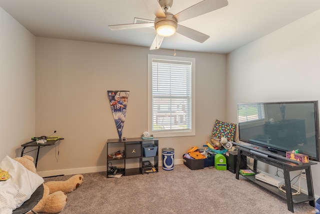 recreation room with carpet, a healthy amount of sunlight, and baseboards