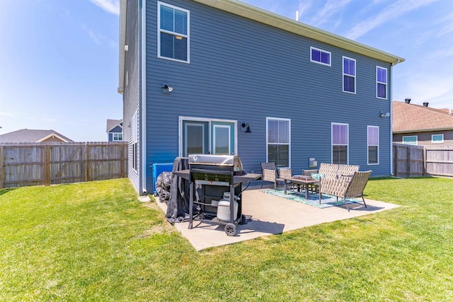 back of property featuring a lawn, a fenced backyard, and a patio