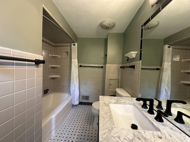 6065 Gladden Dr, Indianapolis, IN 46220 - full bathroom featuring shower / bath combo, a wainscoted wall, toilet, tile walls, and vanity