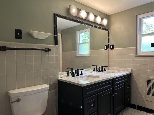 6065 Gladden Dr, Indianapolis, IN 46220 - full bath featuring tile walls, a wainscoted wall, a sink, and toilet