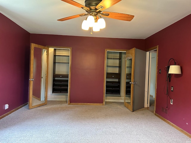 6065 Gladden Dr, Indianapolis, IN 46220 - unfurnished bedroom with multiple closets, carpet flooring, and baseboards