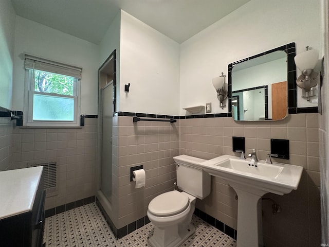 6065 Gladden Dr, Indianapolis, IN 46220 - full bath featuring a wainscoted wall, a stall shower, tile walls, toilet, and visible vents
