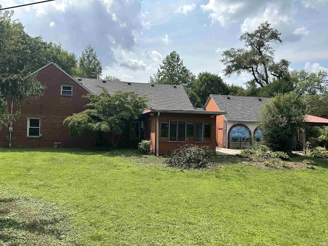 6065 Gladden Dr, Indianapolis, IN 46220 - back of house featuring a gazebo, a lawn, and a garage