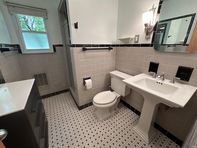 6065 Gladden Dr, Indianapolis, IN 46220 - full bathroom with wainscoting, a shower stall, toilet, and tile walls