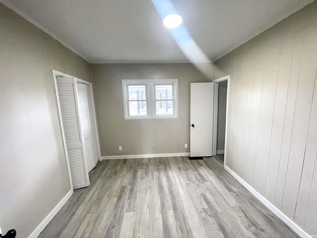 318 W 10th St, Bicknell, IN 47512 - unfurnished bedroom with wood finished floors, a closet, and baseboards