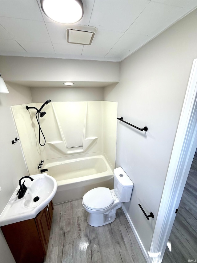 full bath featuring toilet, vanity, wood finished floors, and shower / bathing tub combination