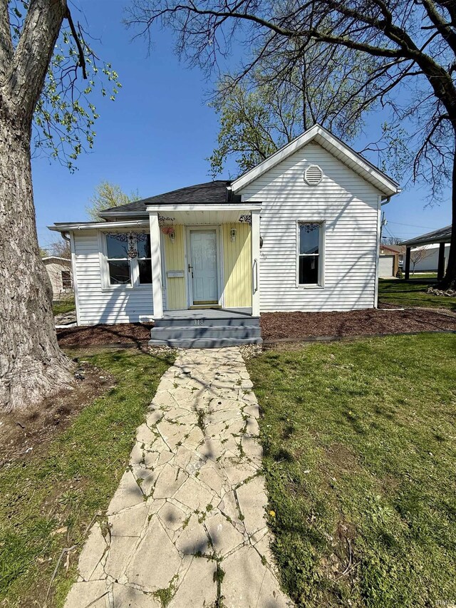 318 W 10th St, Bicknell, IN 47512 - view of front facade with a front lawn and board and batten siding