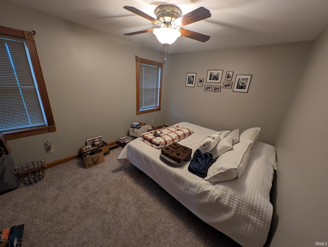 carpeted bedroom with baseboards and ceiling fan
