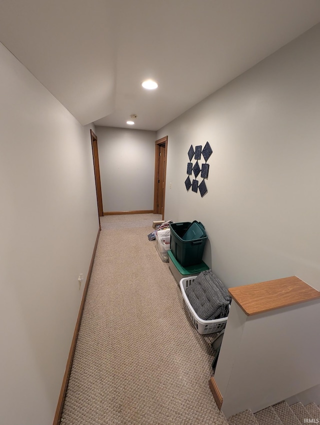 hallway featuring baseboards, carpet floors, and recessed lighting
