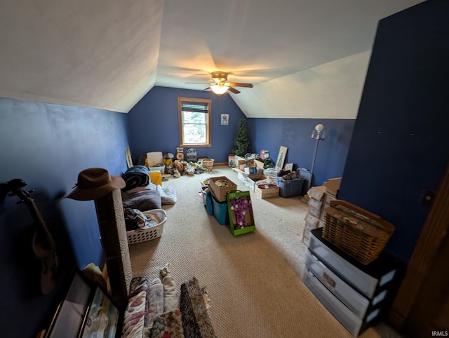 interior space with vaulted ceiling, carpet floors, and ceiling fan
