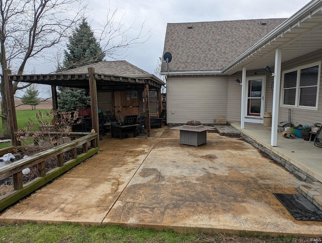 view of patio featuring a gazebo and an outdoor living space with a fire pit