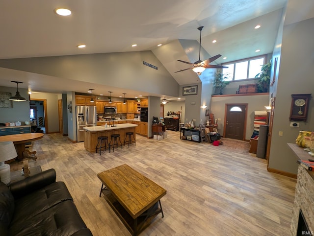 living area with high vaulted ceiling, ceiling fan, recessed lighting, and light wood-style flooring