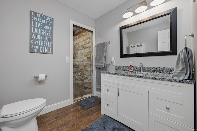 6891 E Hopewell Rd, Avilla, IN 46710 - full bathroom with toilet, wood finished floors, vanity, baseboards, and tiled shower