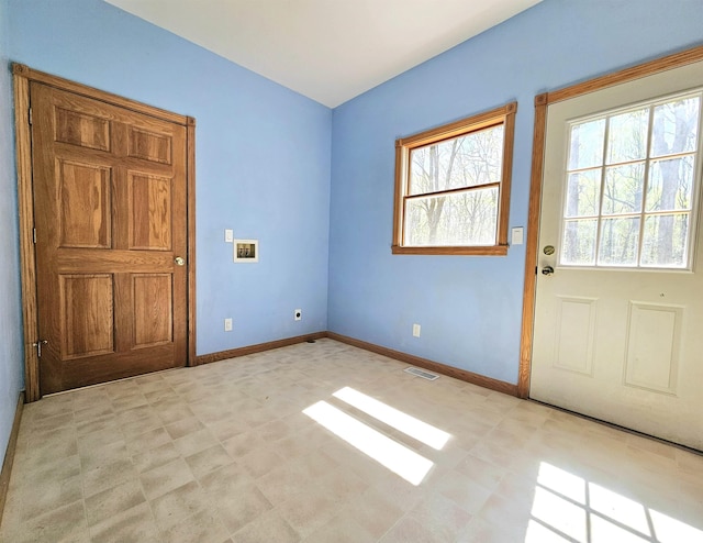 interior space with visible vents, baseboards, and light floors