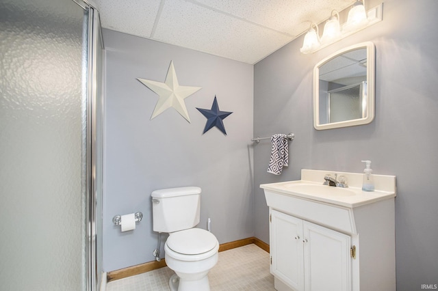 full bathroom with toilet, an enclosed shower, vanity, and baseboards