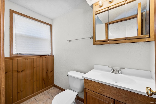 bathroom with tile patterned floors, baseboards, vanity, and toilet