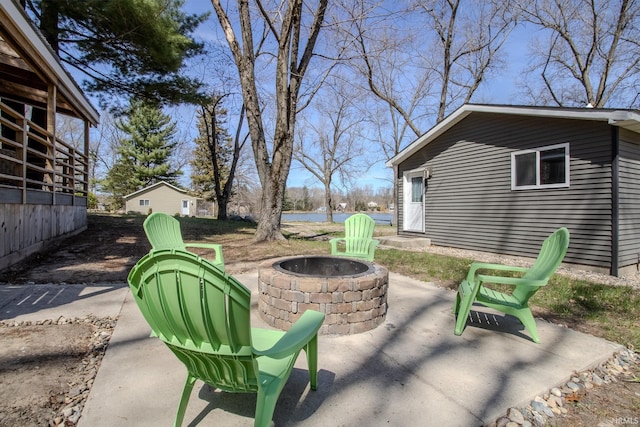 10510 E Orange St, Monterey, IN 46960 - view of patio / terrace with a water view and an outdoor fire pit