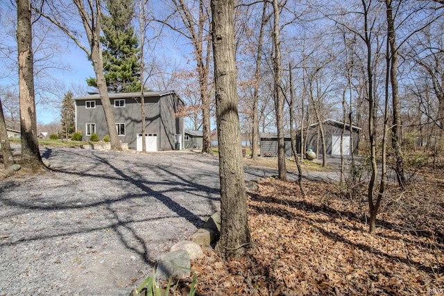 10510 E Orange St, Monterey, IN 46960 - view of yard featuring gravel driveway and a garage