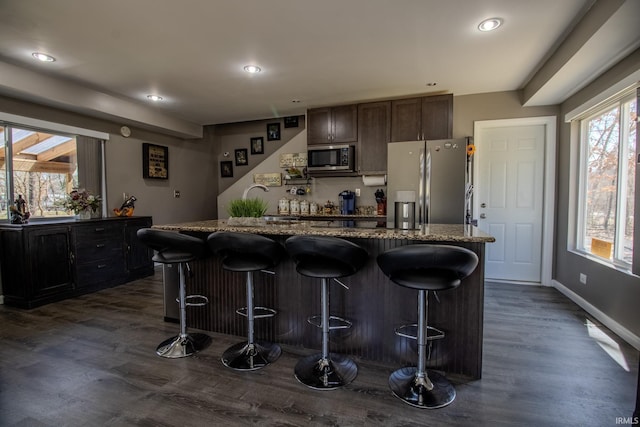 10510 E Orange St, Monterey, IN 46960 - kitchen with dark wood-style flooring, a kitchen bar, recessed lighting, a center island, and appliances with stainless steel finishes