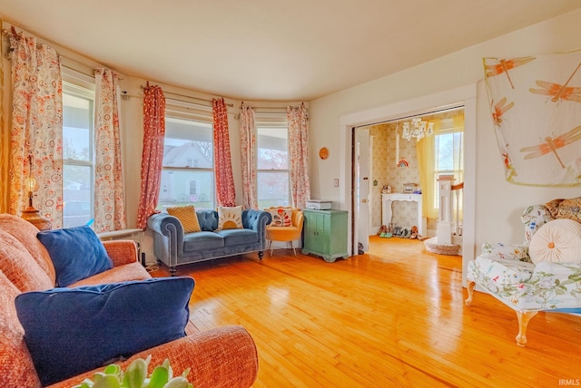 living room with a chandelier and light wood finished floors