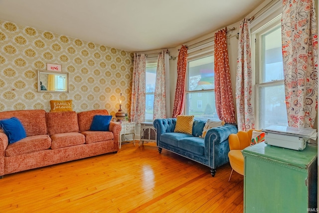 living area featuring wallpapered walls and light wood-style flooring