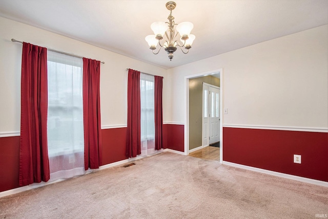 22486 Fireside Dr, Goshen, IN 46528 - carpeted empty room featuring baseboards, visible vents, and a notable chandelier