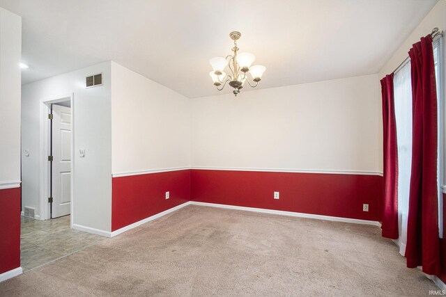 22486 Fireside Dr, Goshen, IN 46528 - unfurnished room with carpet, visible vents, baseboards, and a notable chandelier