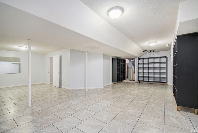 22486 Fireside Dr, Goshen, IN 46528 - finished below grade area featuring baseboards, a textured ceiling, and light tile patterned floors