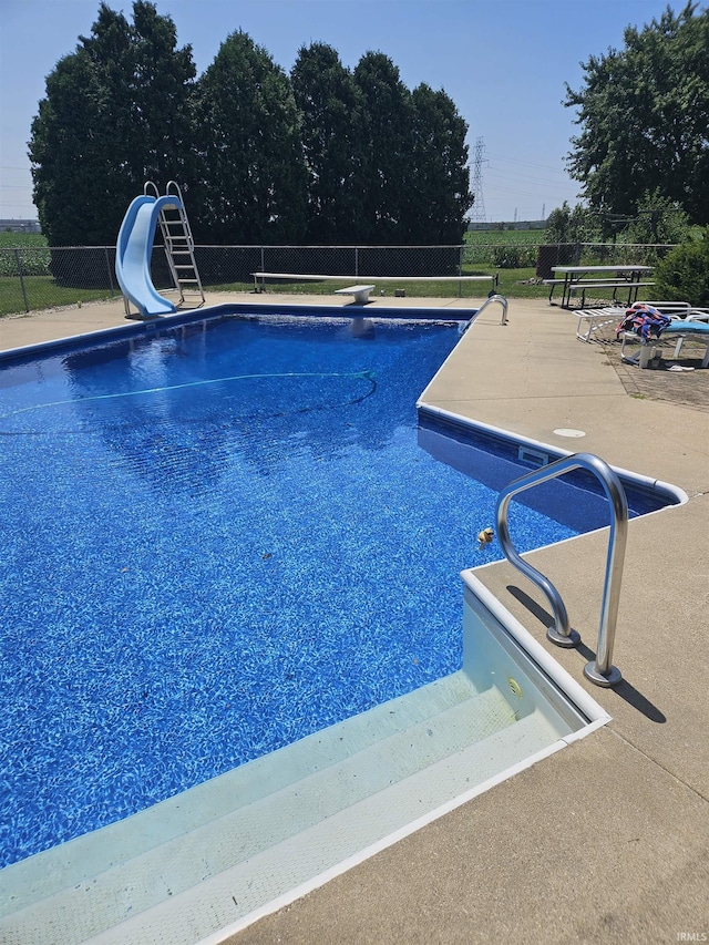 30888 US Highway 20, New Carlisle, IN 46552 - view of pool with a water slide, fence, a diving board, and a patio area