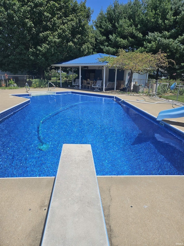 30888 US Highway 20, New Carlisle, IN 46552 - view of swimming pool with fence, a water slide, a patio, and a diving board