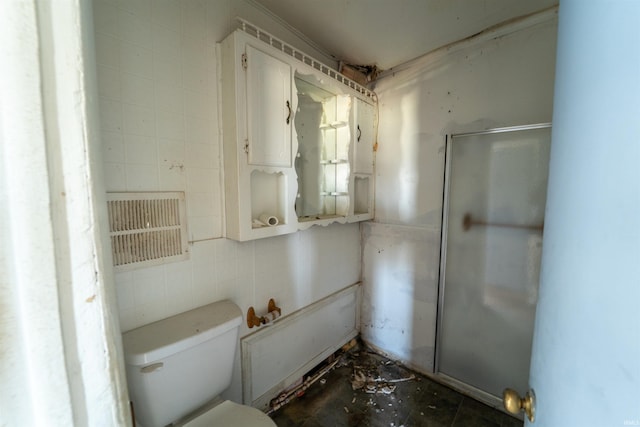 bathroom featuring tile walls and toilet