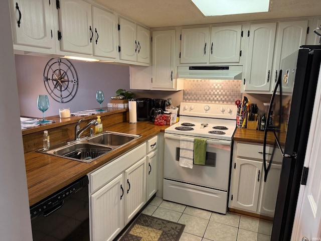 kitchen with wooden counters, under cabinet range hood, light tile patterned floors, a sink, and black appliances