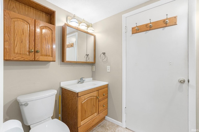 8763 E Backwater Rd, North Webster, IN 46555 - half bathroom with tile patterned floors, baseboards, vanity, and toilet