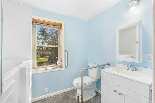 8763 E Backwater Rd, North Webster, IN 46555 - bathroom featuring vanity, toilet, and baseboards