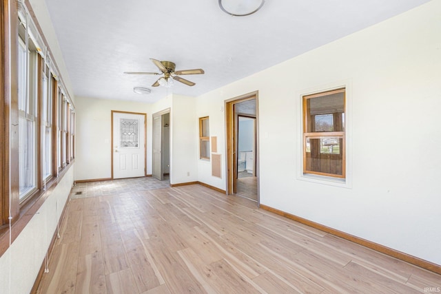 8763 E Backwater Rd, North Webster, IN 46555 - interior space with light wood finished floors, baseboards, a wealth of natural light, and ceiling fan