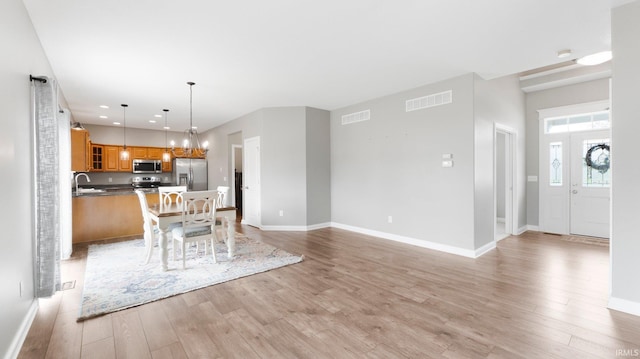 interior space with baseboards, visible vents, recessed lighting, and light wood-style floors